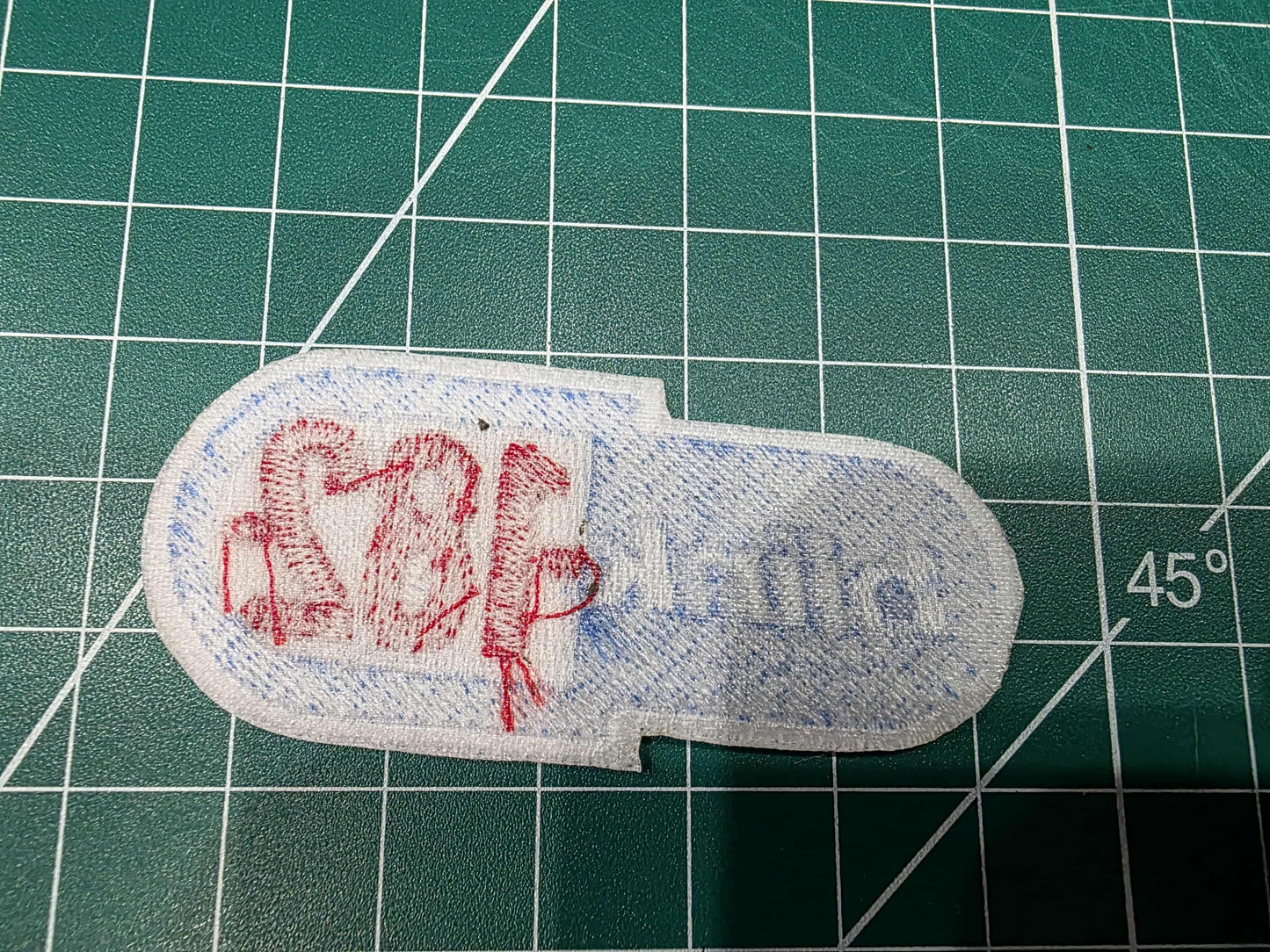 Fabric patch with text on a green cutting mat